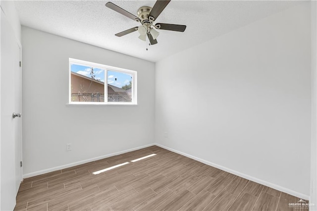 unfurnished room with ceiling fan, light hardwood / wood-style flooring, and a textured ceiling