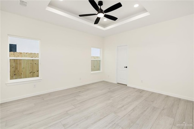5204 Shalom Dr, Edinburg, TX 78539 - unfurnished room with a raised ceiling, a ceiling fan, light wood-style floors, recessed lighting, and baseboards