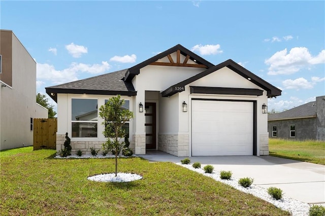 5204 Shalom Dr, Edinburg, TX 78539 - view of front of property with stone siding, stucco siding, an attached garage, and driveway