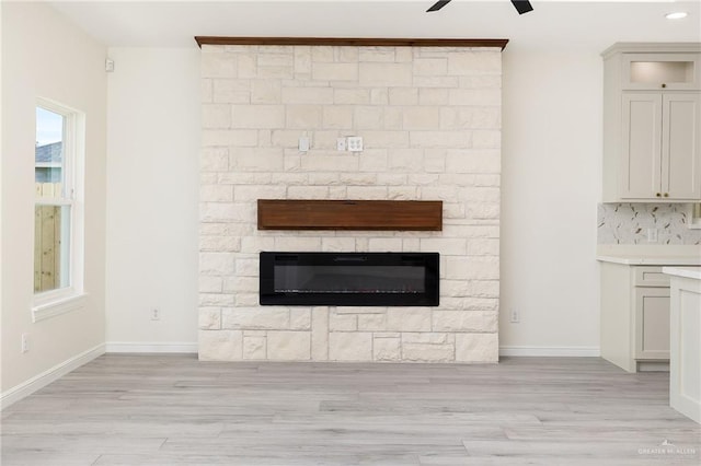 5204 Shalom Dr, Edinburg, TX 78539 - detailed view of wood finished floors, ceiling fan, a glass covered fireplace, baseboards, and recessed lighting