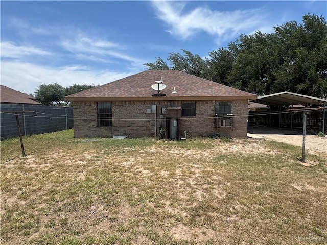 412 Silverado Dr E, Palmview, TX 78572 - rear view of property with brick siding, a detached carport, and roof with shingles