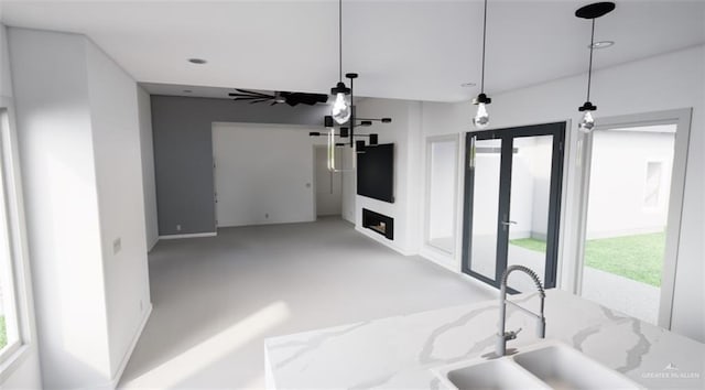 unfurnished living room with baseboards, carpet flooring, a sink, and recessed lighting