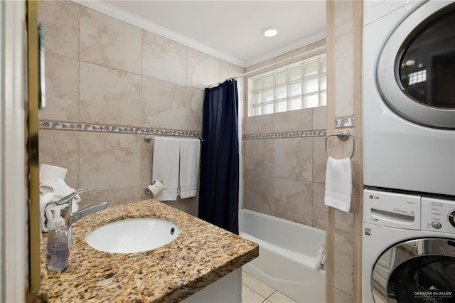 bathroom with tile patterned floors, stacked washer / drying machine, shower / tub combo with curtain, tile walls, and ornamental molding