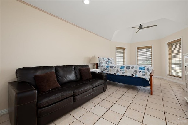 bedroom with ceiling fan, light tile patterned flooring, and lofted ceiling