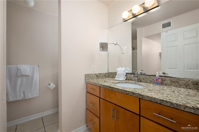 bathroom featuring tile patterned flooring, vanity, and ornamental molding