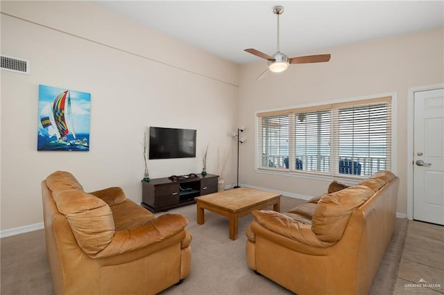 carpeted living room with ceiling fan