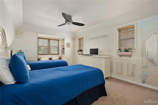 carpeted bedroom featuring multiple windows and ceiling fan