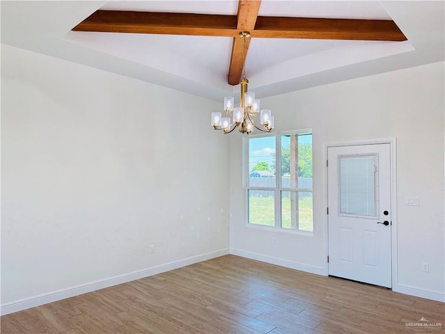 2125 Blue Sky Dr, Weslaco, TX 78599 - unfurnished dining area featuring a chandelier, beamed ceiling, and light wood finished floors