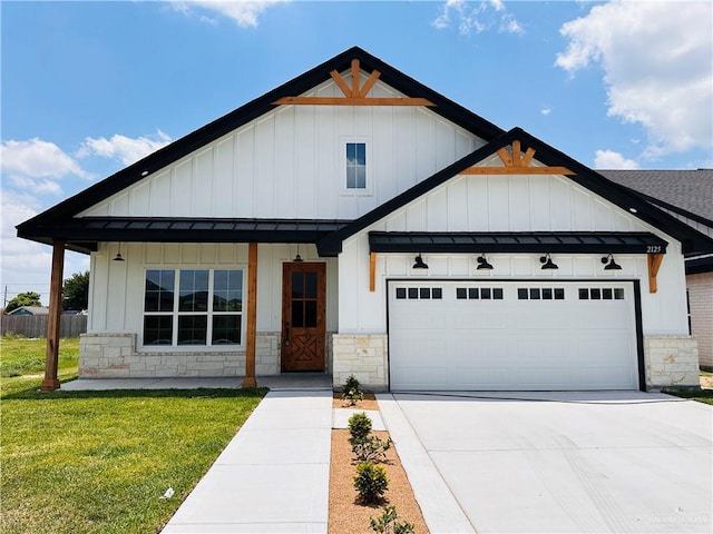 2125 Blue Sky Dr, Weslaco, TX 78599 - modern farmhouse featuring board and batten siding, stone siding, driveway, and an attached garage