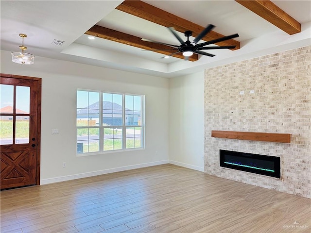 2125 Blue Sky Dr, Weslaco, TX 78599 - unfurnished living room with beam ceiling, wood finished floors, a tray ceiling, a ceiling fan, and plenty of natural light