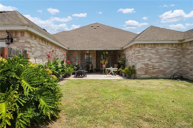 back of house with a patio area and a yard