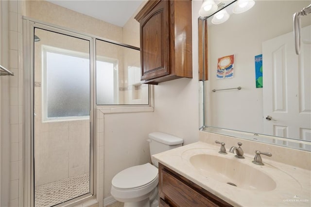 bathroom with vanity, toilet, and an enclosed shower