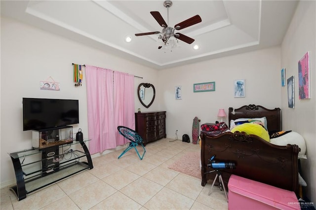 tiled bedroom with a raised ceiling and ceiling fan