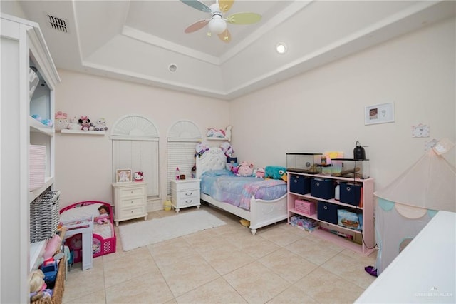 bedroom with ceiling fan, light tile patterned flooring, and a raised ceiling