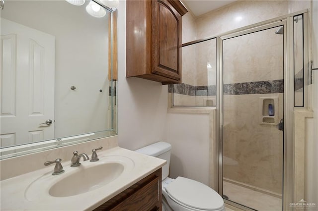 bathroom featuring vanity, a shower with shower door, and toilet