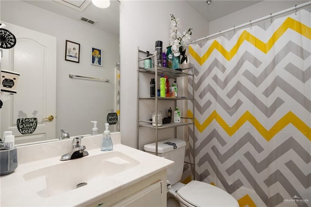 bathroom featuring walk in shower, vanity, and toilet