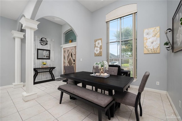 tiled dining room featuring ornate columns