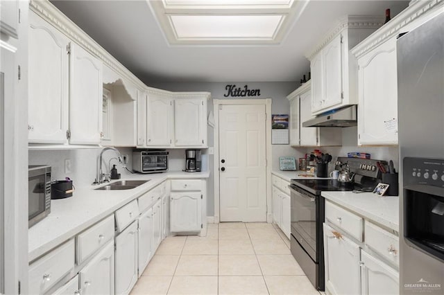 kitchen featuring light tile patterned floors, stainless steel appliances, white cabinetry, and sink