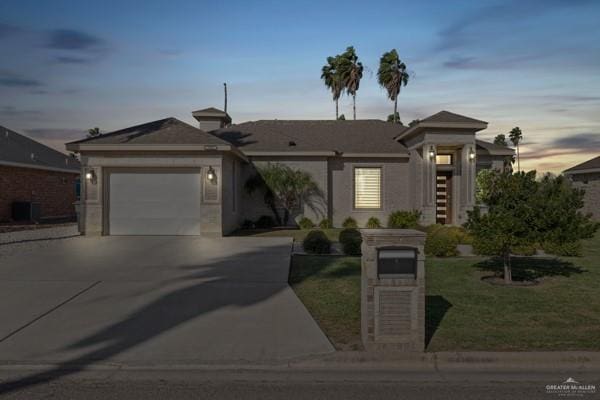 view of front of home featuring a garage and a yard