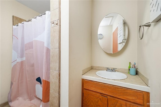 bathroom featuring curtained shower and vanity