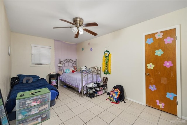 bedroom with ceiling fan and light tile patterned flooring