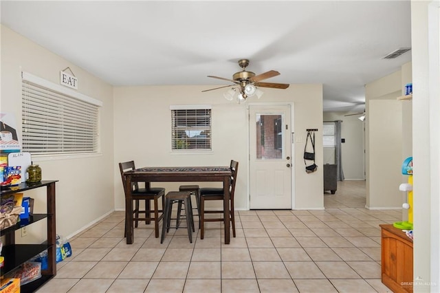 dining room with ceiling fan and light tile patterned floors