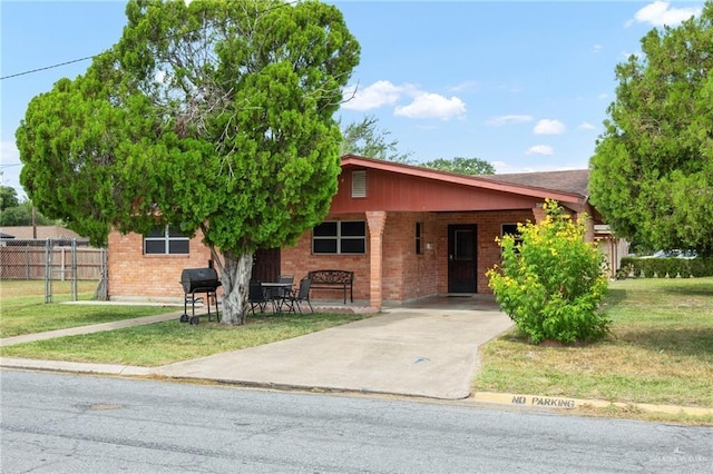 ranch-style house with a carport and a front lawn