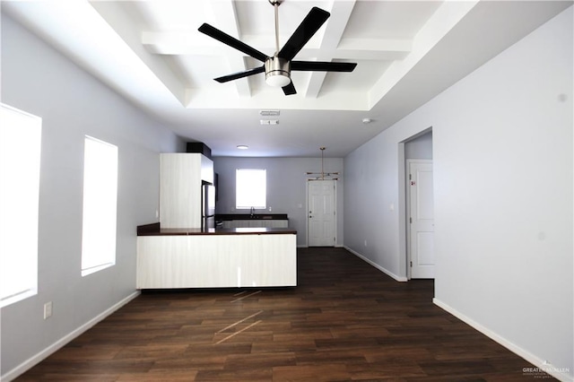 kitchen with dark hardwood / wood-style flooring, kitchen peninsula, stainless steel refrigerator, and ceiling fan