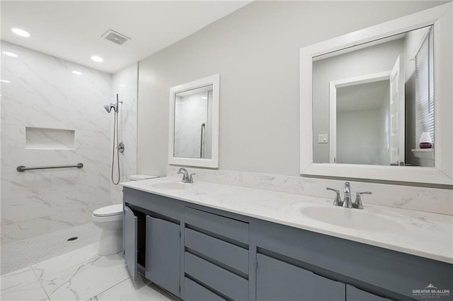 full bath featuring double vanity, marble finish floor, visible vents, and a sink