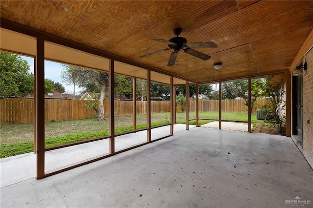 unfurnished sunroom featuring wood ceiling and a ceiling fan