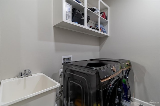 laundry room featuring independent washer and dryer and sink