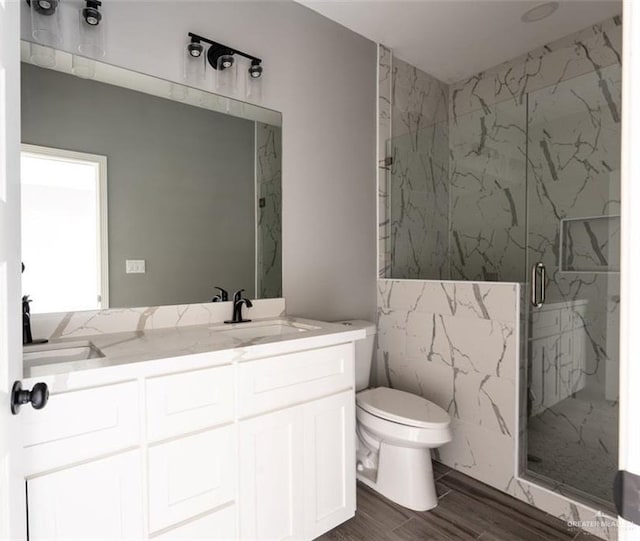 bathroom with vanity, an enclosed shower, and toilet