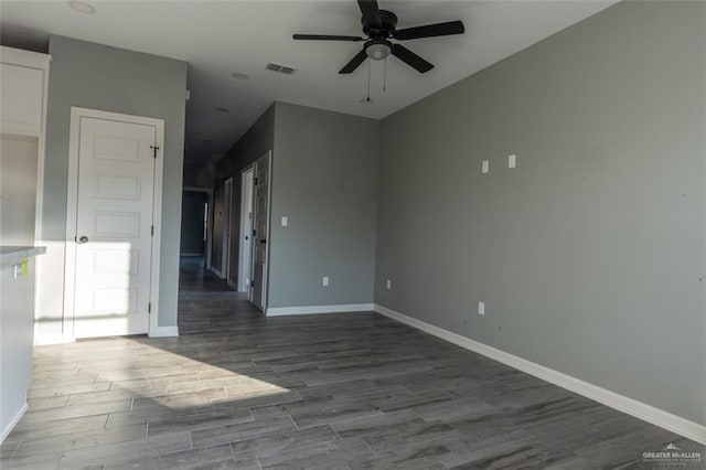 spare room featuring wood-type flooring and ceiling fan