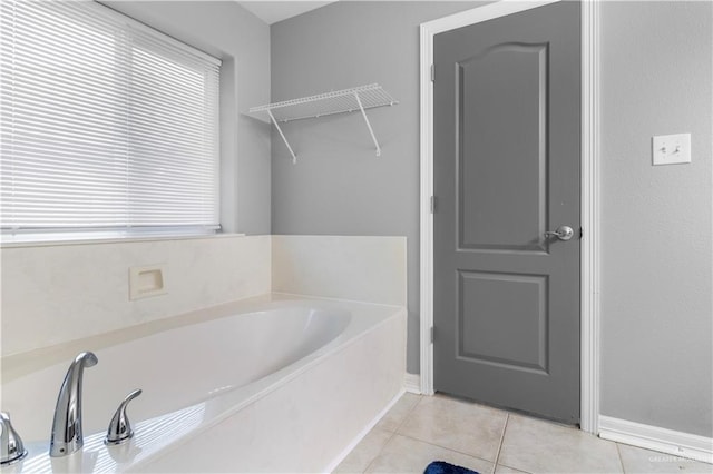 full bath featuring tile patterned flooring and a bath