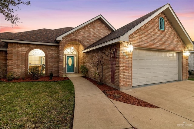 view of front of property featuring a garage and brick siding