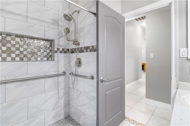 bathroom with a shower stall, visible vents, baseboards, and tile patterned floors