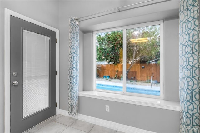 entryway featuring tile patterned flooring and baseboards