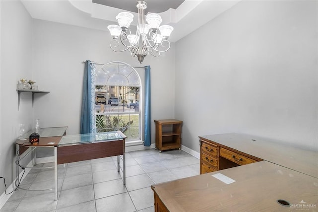 office space featuring a chandelier, a raised ceiling, baseboards, and light tile patterned floors