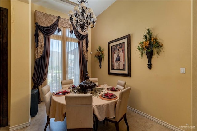 dining room with light tile patterned floors and an inviting chandelier