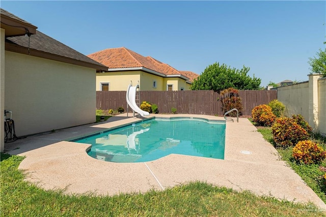 view of swimming pool featuring a patio area and a water slide