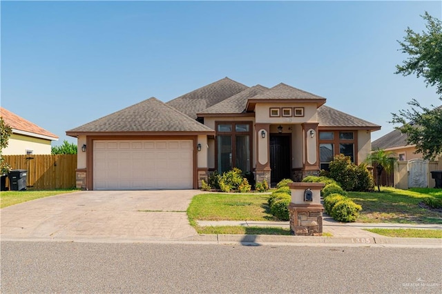 view of front of house with a garage and a front lawn