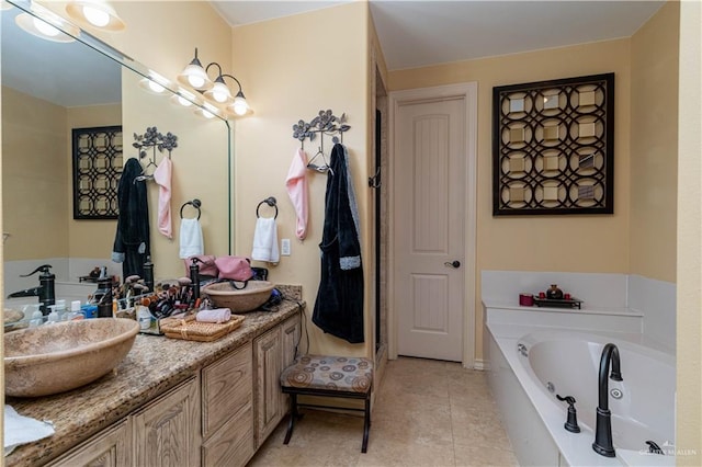 bathroom with tile patterned flooring, vanity, and a relaxing tiled tub