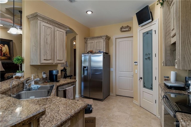 kitchen with light brown cabinets, hanging light fixtures, sink, appliances with stainless steel finishes, and light tile patterned flooring