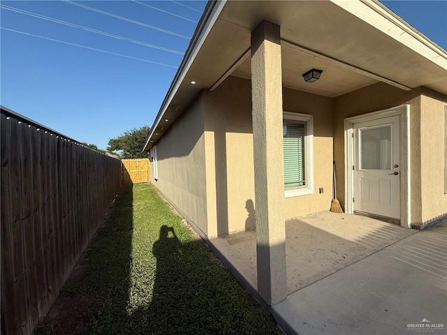 2315 N Ruby Dr, Edinburg, TX 78541 - view of property exterior with stucco siding, a patio, and a fenced backyard