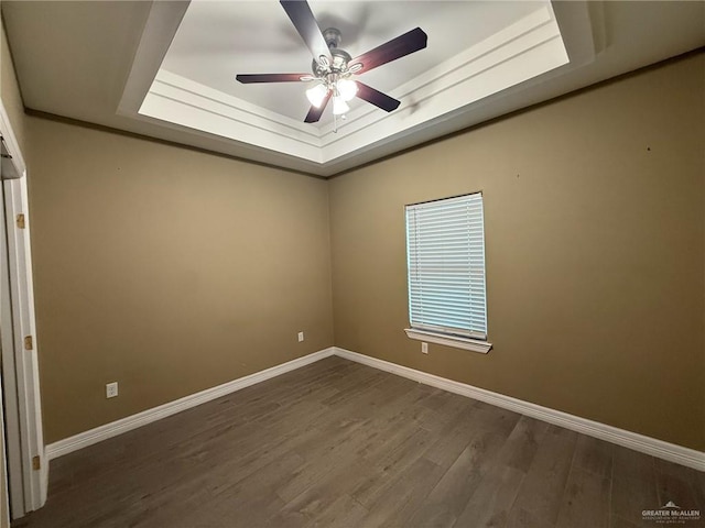 2315 N Ruby Dr, Edinburg, TX 78541 - unfurnished room featuring baseboards, a raised ceiling, wood finished floors, and ceiling fan