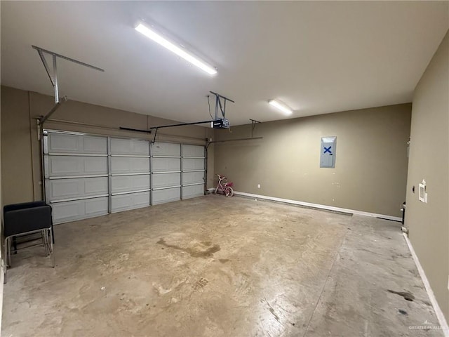 2315 N Ruby Dr, Edinburg, TX 78541 - garage featuring a garage door opener, electric panel, and baseboards