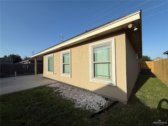 2315 N Ruby Dr, Edinburg, TX 78541 - view of side of property with a patio area, stucco siding, and central air condition unit