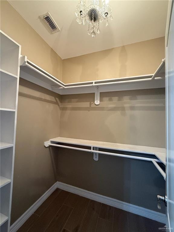 2315 N Ruby Dr, Edinburg, TX 78541 - spacious closet featuring dark wood-style floors and a chandelier