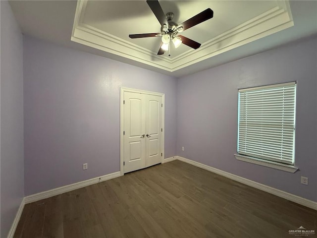 2315 N Ruby Dr, Edinburg, TX 78541 - spare room with a tray ceiling, wood finished floors, baseboards, a ceiling fan, and crown molding