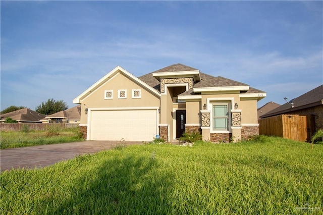 2315 N Ruby Dr, Edinburg, TX 78541 - view of front of home with stone siding, stucco siding, driveway, and an attached garage